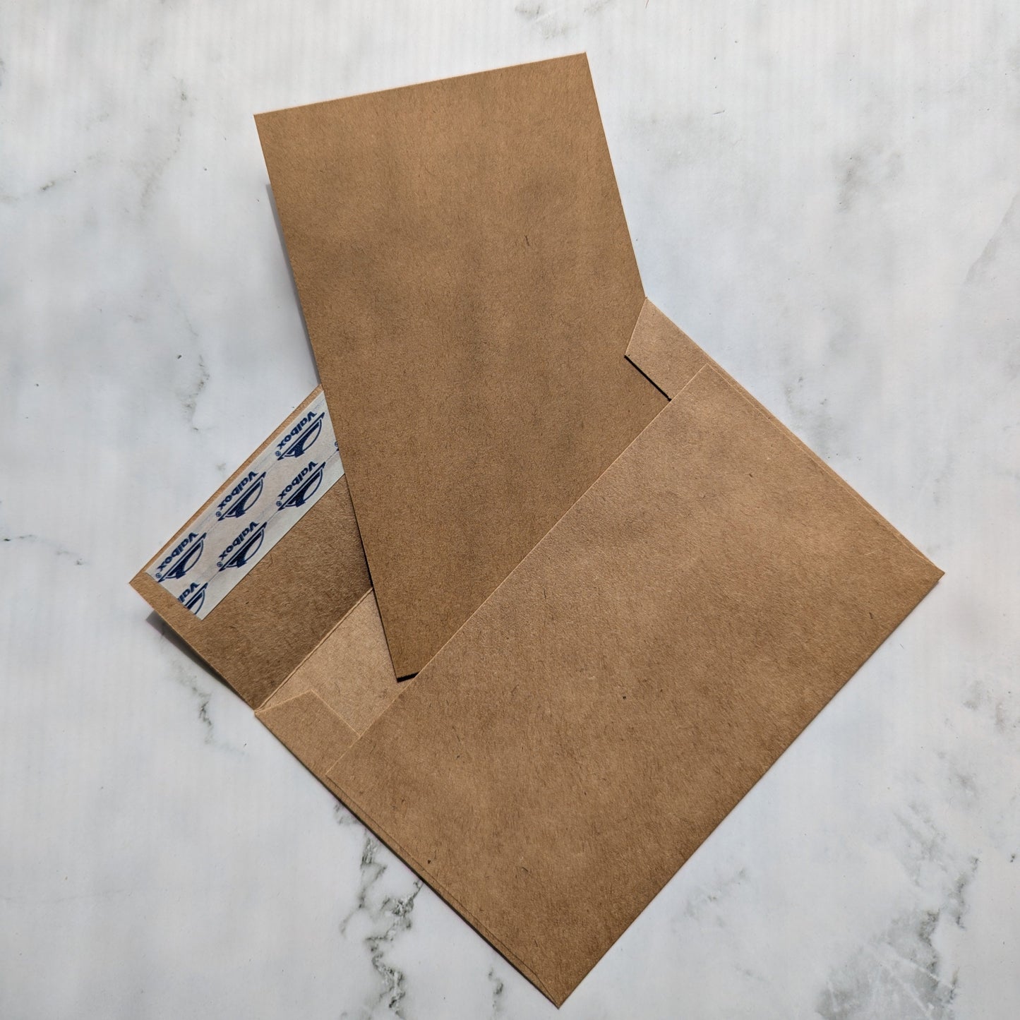 brown kraft envelope and flat card