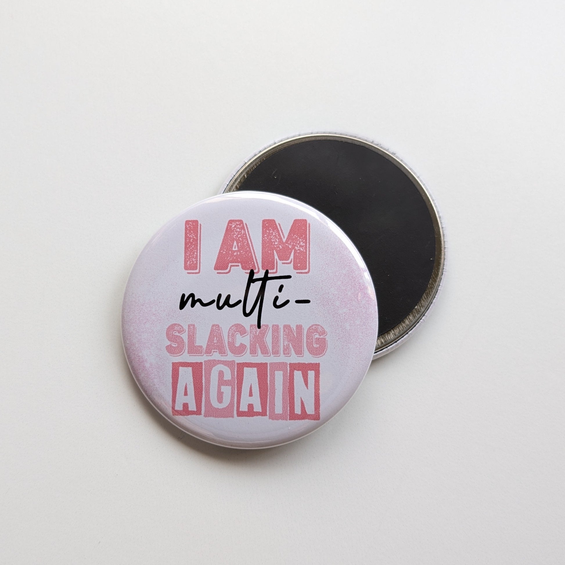 Round magnetic button with text 'I AM multi-slacking AGAIN' on a white background