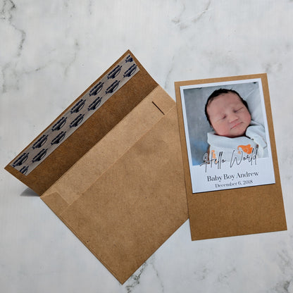 Baby photo magnet with envelope on a marble surface